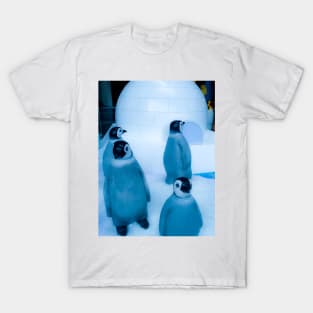 Igloo with a group of penguin sculptures T-Shirt